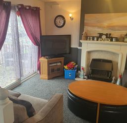 A living room with a sofa and television at the property in Fleetwood