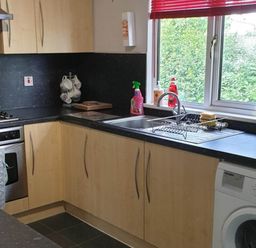 A kitchen with an oven, stove, sink, and washing machine at The Old Barn in Fleetwood
