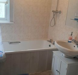 A bathroom with a bathtub and sink at The Old Barn in Fleetwood