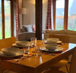 A dining area with a table set for four at Tremail near Camelford