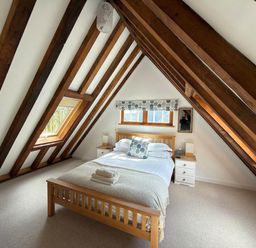 A bedroom with a bed and two nightstands at Tremail near Camelford