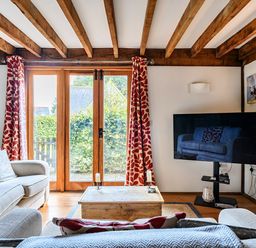 A living room with a television and a coffee table at Cabin Sleeps 6 with Parking and Patio in Tremail near Camelford