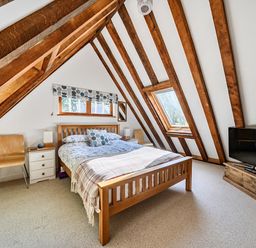 A bedroom with a bed and television at Cabin Sleeps 6 with Parking and Patio, Tremail near Camelford