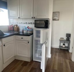 A kitchen with a refrigerator and washing machine at Bridlington