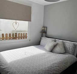 A bedroom with a bed and window at the property in Bridlington