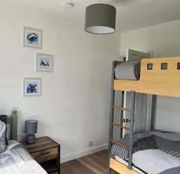 A bedroom with a bunk bed and a single bed at The Old Barn in Bridlington