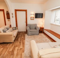 A living room with two sofas and a television at Spinnaker