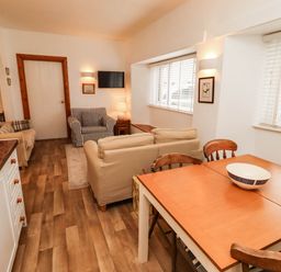 A living room with furniture and a table at Spinnaker