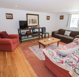A living room with a sofa and coffee table at Wayside in Moreton-in-Marsh