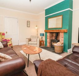A living room with a fireplace and sofa at Westgate Willows in Nafferton