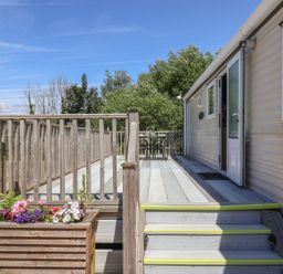 An outdoor area with a deck and seating at The Hideaway in Portesham