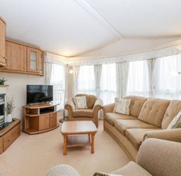 A living room with a sofa and television at The Hideaway in Portesham
