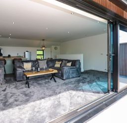 A living room with a sofa and coffee table at Sycamore Cottage in Frizington