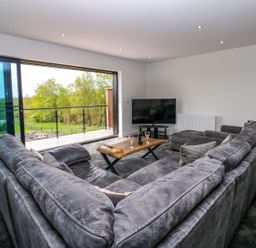 A living room with a sofa and coffee table at Sycamore Cottage in Frizington