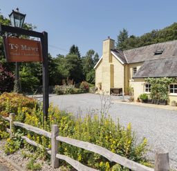 A hotel building with a sign at Ty Mawr Country House in Carmarthen