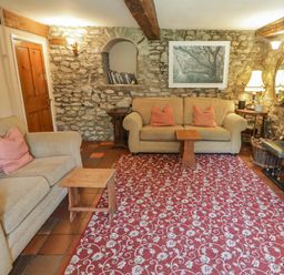 A living room with a sofa and coffee table at Ty Mawr Country House in Carmarthen