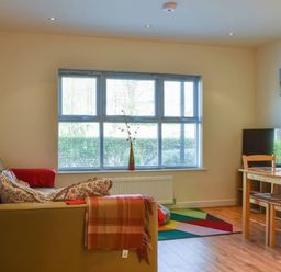 A living room with a sofa and a table at Admirals Rest in Weymouth