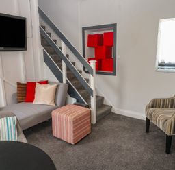 A living room with a sofa and television at 1 St. Day Road in Redruth