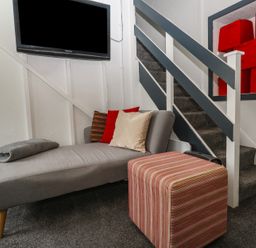 A living room with a sofa and television at 1 St. Day Road in Redruth