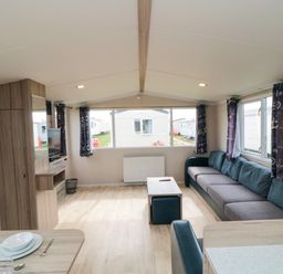 A living room with a sofa and a coffee table at 42 Oak Green