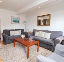 A living room with a sofa and coffee table at Iris at Stancombe Manor, Sherford near Chillington