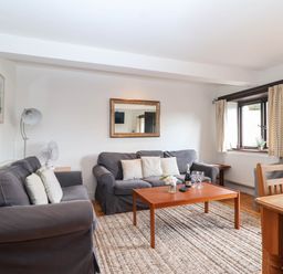 A living room with a sofa and dining table at Iris at Stancombe Manor in Sherford near Chillington