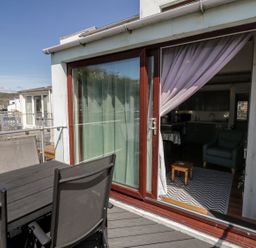An outdoor patio with a table and chairs at Seafarer's Haven in Porthmadog