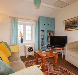 A living room with a sofa and television at The Granary 