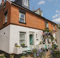 An exterior view of a house with garden at Tower View Cottage in Lympstone