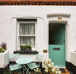 A front door with a window and seating at Tower View Cottage in Lympstone
