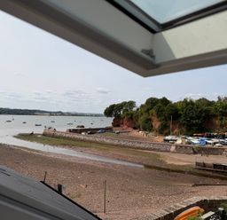 View from a window showing boats on water at Tower View Cottage in Lympstone