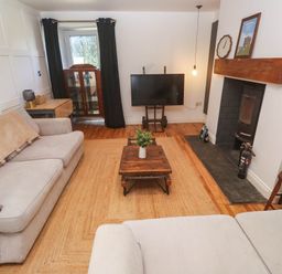 A living room with a sofa and television at The Lookout in Redruth
