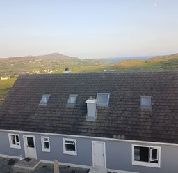 A house with a grey exterior and chimney at Sliabh League Mountain Lodge TEILEANN near Kilcar, County Donegal