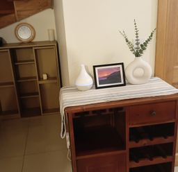 A dining table with a vase and photo at Sliabh League Mountain Lodge, TEILEANN near Kilcar, County Donegal