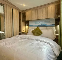 A bedroom with a bed and wardrobes at 101 Bay View in Ayr