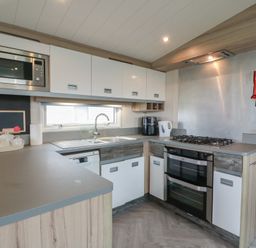 A kitchen with various appliances and cabinetry at 101 Bay View in Ayr