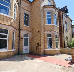 An exterior view of a house with windows and a pathway at Lansdowne Grange in Bridlington