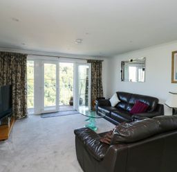 A living room with sofas and a television at 2 Inglewood Apartments in Dartmouth