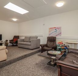 A living room with sofas and a television at Newseal House 