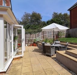 A garden with seating area and plants at Manning's View in Barnstaple