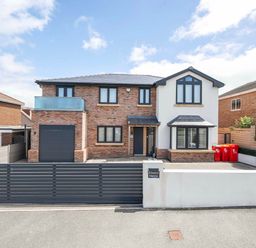 A house with a garage and driveway at Rhosyn Melyn in Abergele
