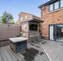 An outdoor area featuring a bar and seating at The Old Barn in Abergele