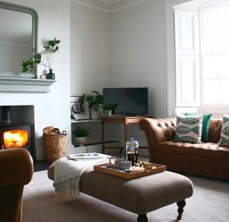 A living room with a sofa, armchair, coffee table, and television at Beautiful 6Bed Sleeps 12 Stunning Views Lynton
