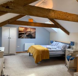 A bedroom with a bed and wardrobe at 1 bed cottage Parking Patio close to coasts Coads Green near Launceston
