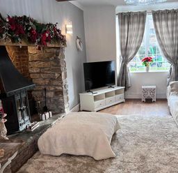 A living room with a fireplace and television at Build your memories hot tub garden sleeps 14 Nottage