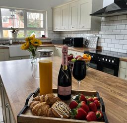 A kitchen with food and drinks on a tray at Build your memories hot tub garden sleeps 14 in Nottage