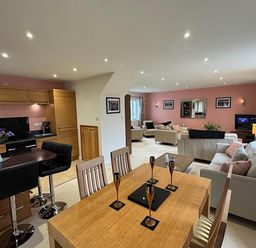A dining area and living room with furniture at River Tamar Couples Retreat Dog Friendly in Newbridge