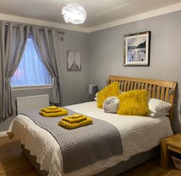 A bedroom with a bed, pillows, and a nightstand at Blairgowrie Luxury 3 Bed Lodge with Hot Tub, Blairgowrie