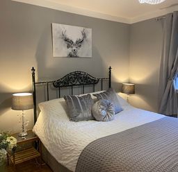 A bedroom with a bed and a picture on the wall at Blairgowrie Luxury 3 Bed Lodge with Hot Tub, Blairgowrie