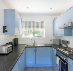 A kitchen with cabinets and appliances at 2 Bedrooms overlooking Little Petherick Creek Little Petherick